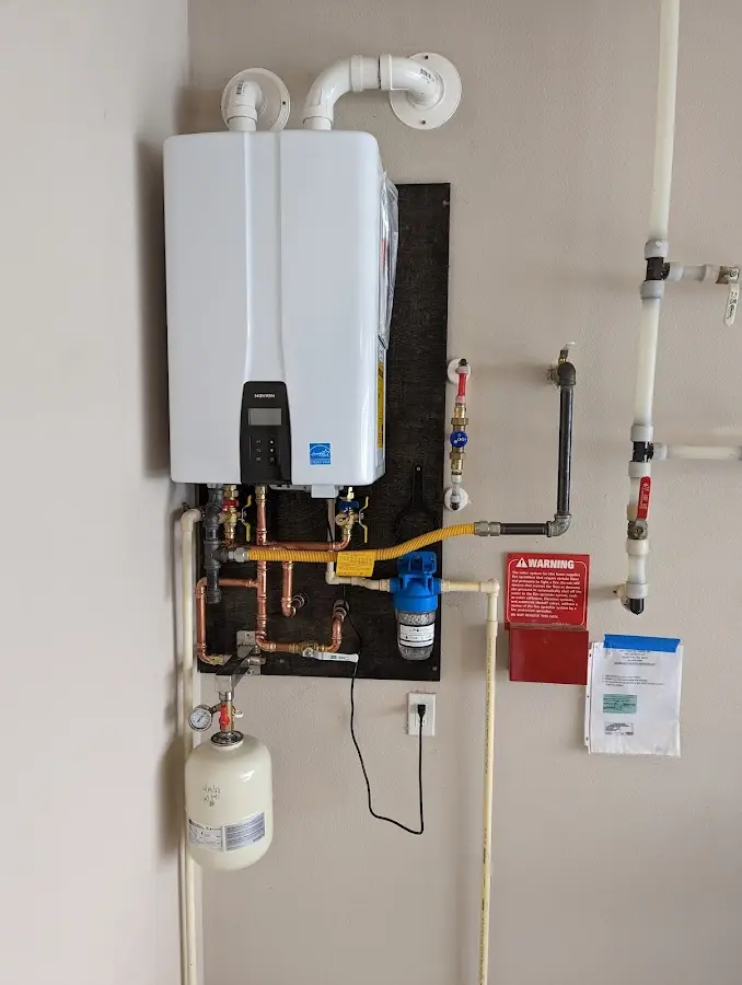 Professional plumber installing copper piping in a Mundelein home